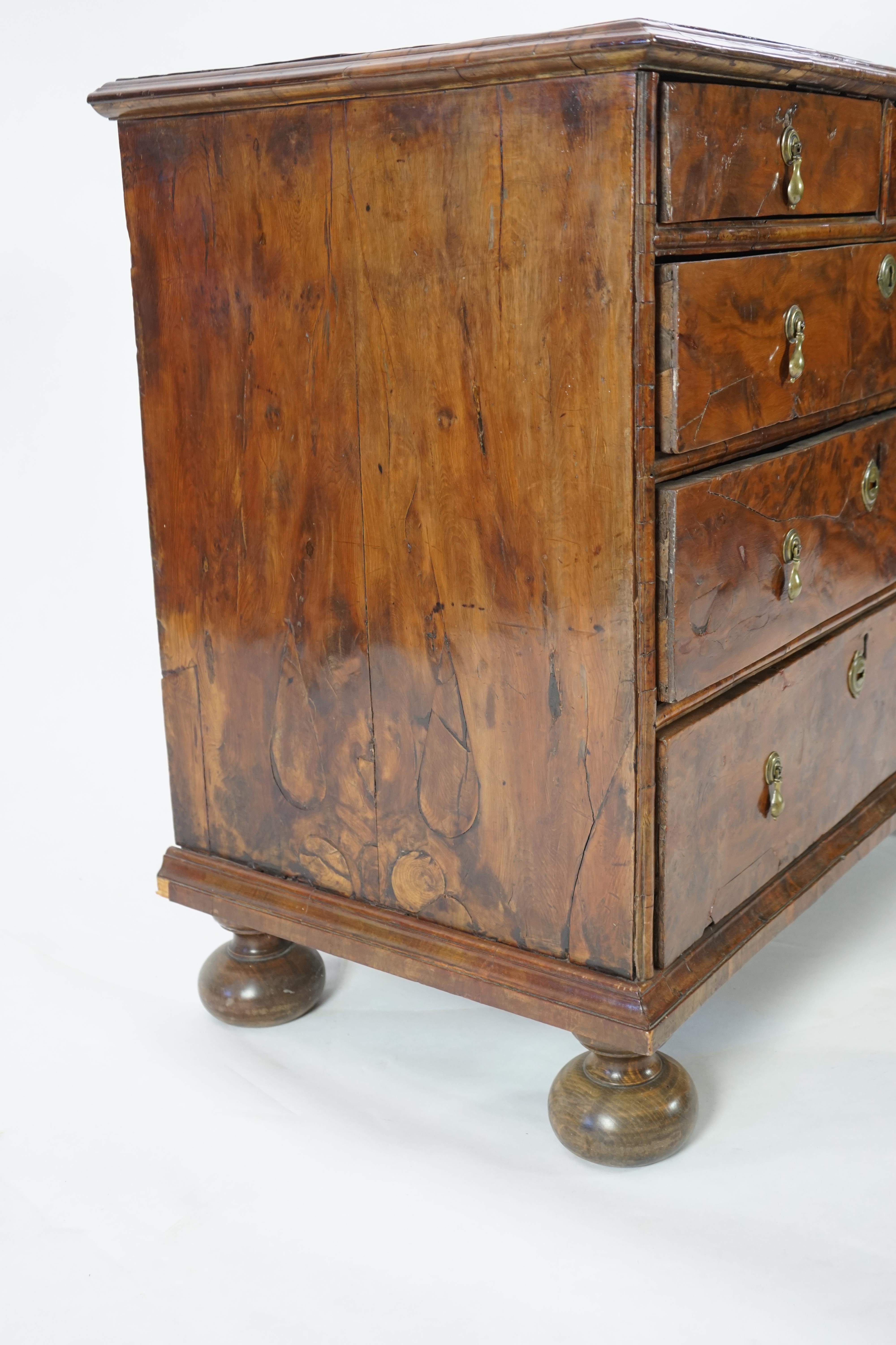 An early 18th century and later yew wood veneered oak chest